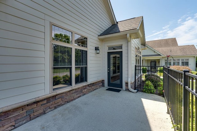 9624 Collier Pl, Ooltewah, TN 37363 - view of exterior entry featuring a patio area and a shingled roof