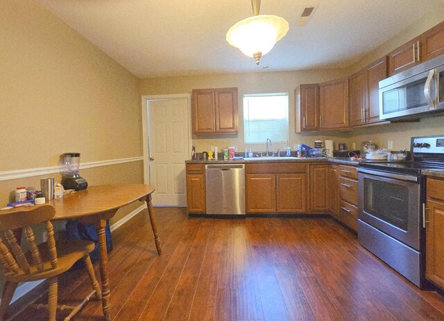 407 W 3rd St, Jasper, TN 37347 - kitchen with stainless steel appliances, dark wood finished floors, brown cabinets, and dark countertops