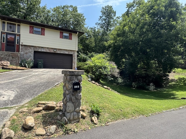 311 Branch Dr, Hixson, TN 37343 - view of front facade featuring driveway, an attached garage, stone siding, and a front yard