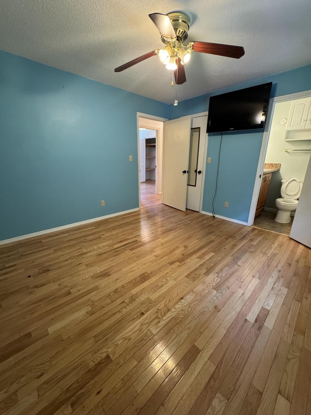 311 Branch Dr, Hixson, TN 37343 - unfurnished bedroom featuring hardwood / wood-style flooring, a textured ceiling, ceiling fan, and ensuite bathroom