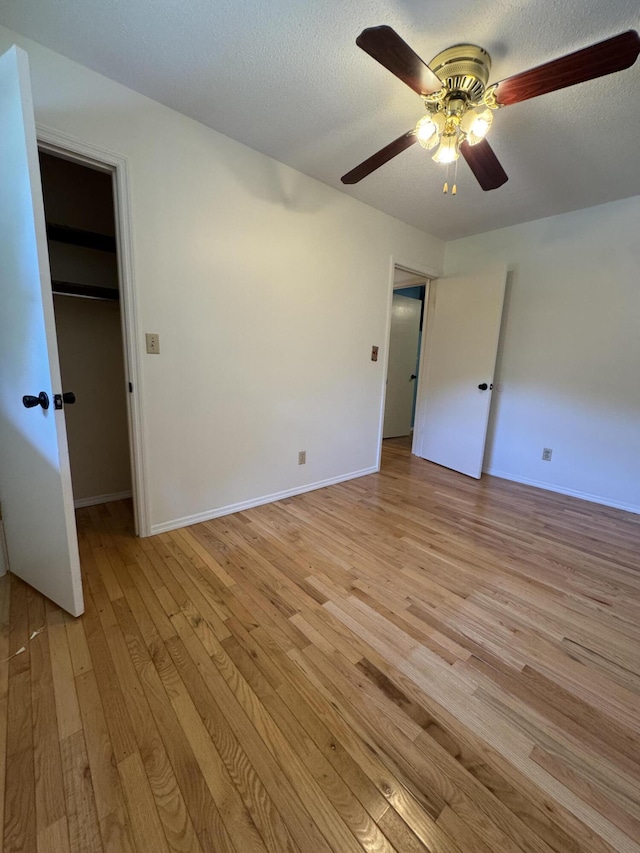311 Branch Dr, Hixson, TN 37343 - unfurnished bedroom featuring light wood-style floors, a walk in closet, a ceiling fan, and a closet