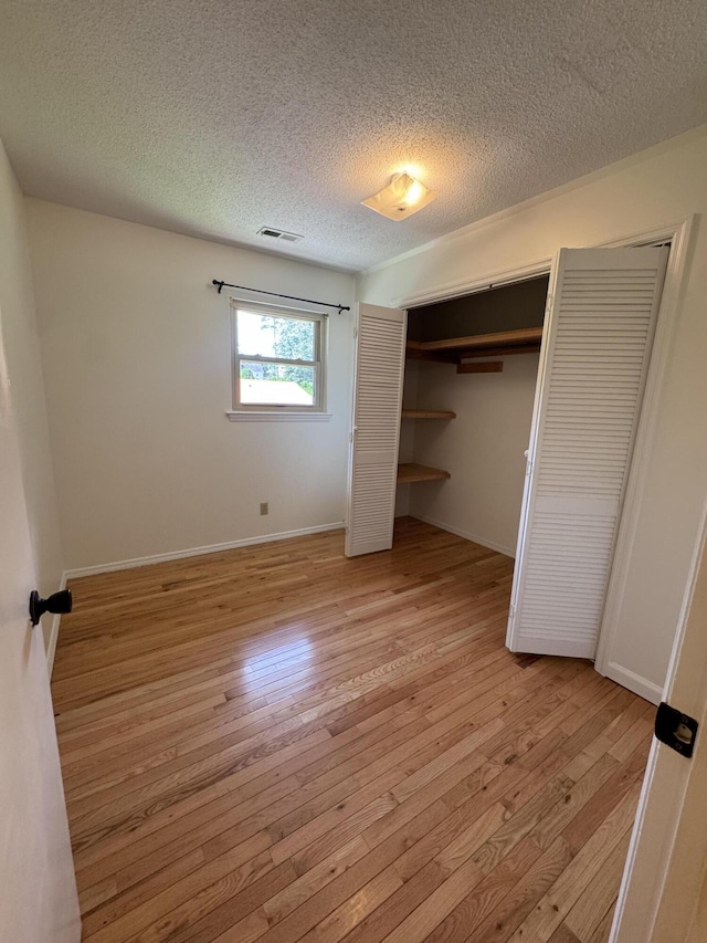 311 Branch Dr, Hixson, TN 37343 - unfurnished bedroom with light wood-type flooring and a textured ceiling