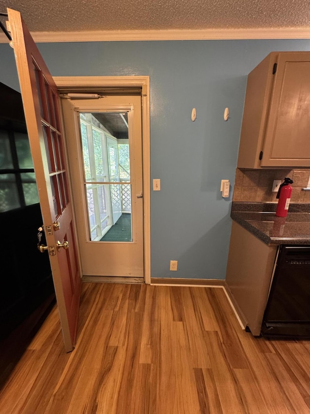 311 Branch Dr, Hixson, TN 37343 - kitchen featuring black dishwasher, light wood finished floors, ornamental molding, and dark countertops