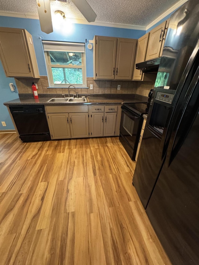 311 Branch Dr, Hixson, TN 37343 - kitchen with black appliances, a textured ceiling, under cabinet range hood, dark countertops, and light wood finished floors