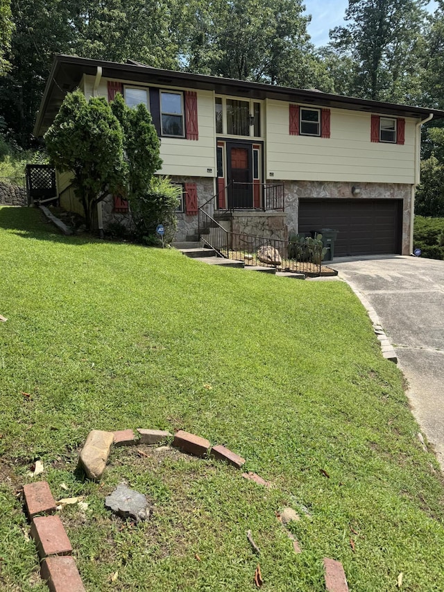 311 Branch Dr, Hixson, TN 37343 - bi-level home featuring a garage, driveway, a front lawn, and stone siding