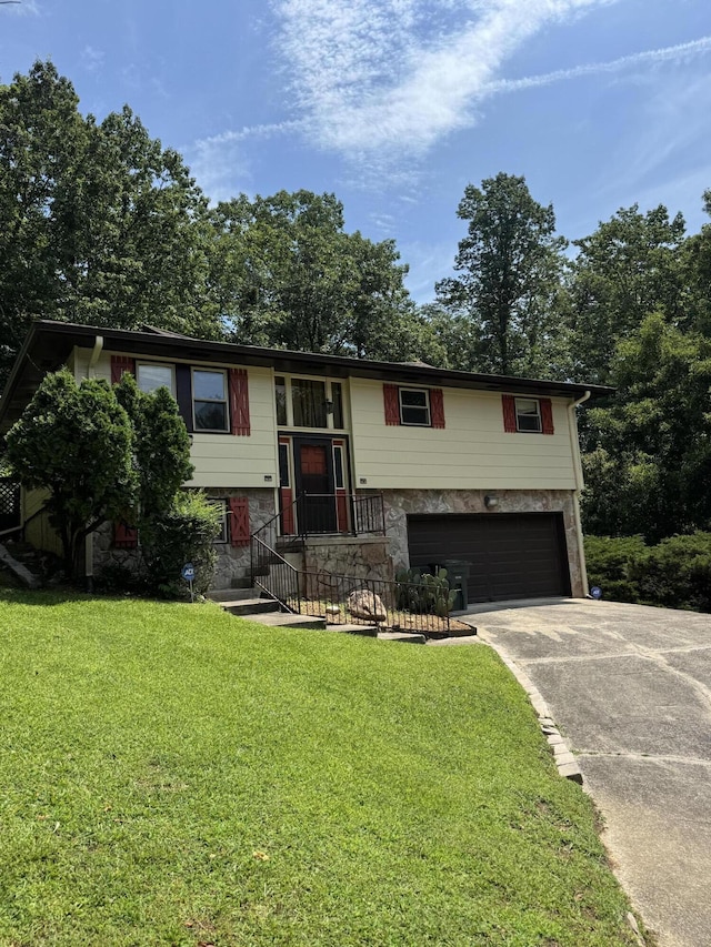 311 Branch Dr, Hixson, TN 37343 - bi-level home with a garage, concrete driveway, a front lawn, and stone siding