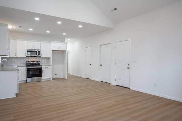 3016 Addison Rd, Chattanooga, TN 37406 - kitchen featuring stainless steel appliances, light wood-style floors, decorative backsplash, recessed lighting, and white cabinets