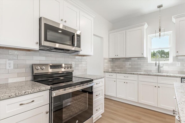 845 James Ave, Chattanooga, TN 37421 - kitchen with appliances with stainless steel finishes, white cabinetry, pendant lighting, light stone counters, and tasteful backsplash