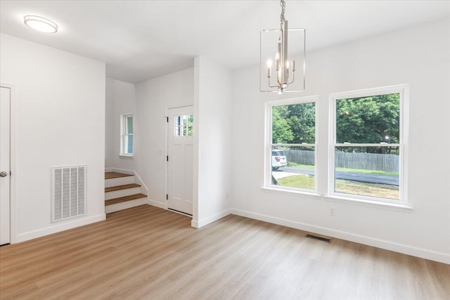 845 James Ave, Chattanooga, TN 37421 - spare room with a chandelier, light wood-style floors, and stairway