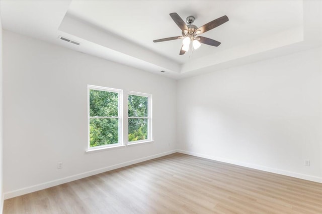 845 James Ave, Chattanooga, TN 37421 - unfurnished room featuring a raised ceiling, light wood finished floors, and a ceiling fan