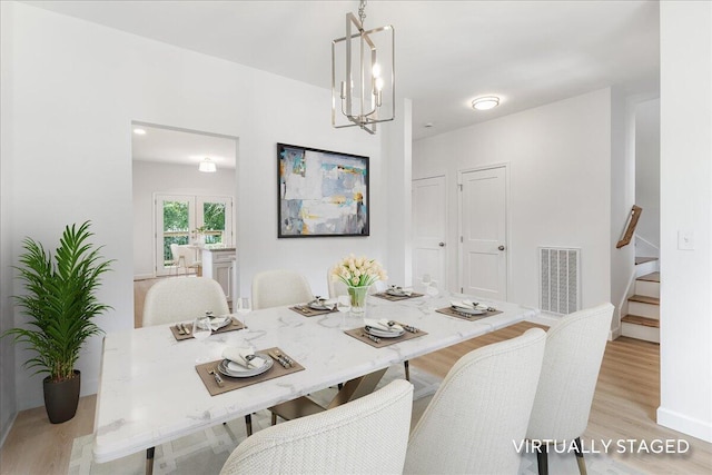 845 James Ave, Chattanooga, TN 37421 - dining space featuring light wood-type flooring, stairs, and a chandelier