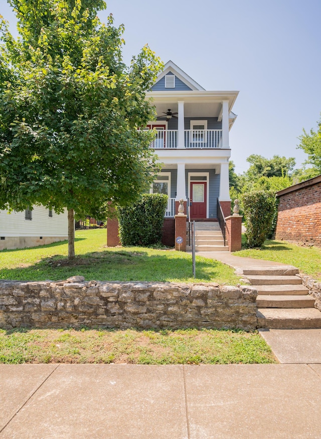 1106 Flynn St, Chattanooga, TN 37403 - view of front facade with a ceiling fan, a porch, a balcony, and a front lawn