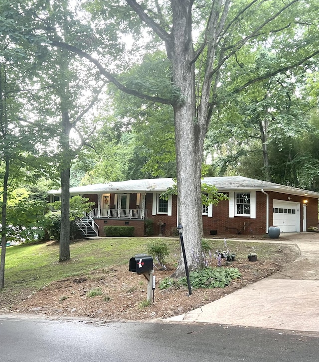 1059 Balmoral Dr, Signal Mountain, TN 37377 - single story home with an attached garage, brick siding, a porch, concrete driveway, and a front lawn