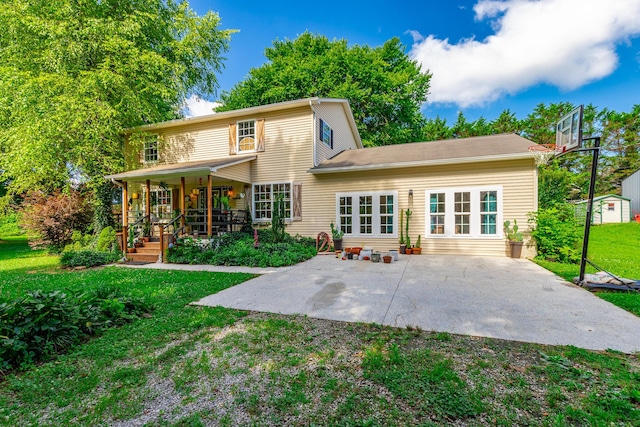 1727 Saunders Rd, Ringgold, GA 30736 - rear view of property featuring a porch, a lawn, a storage unit, and a patio area