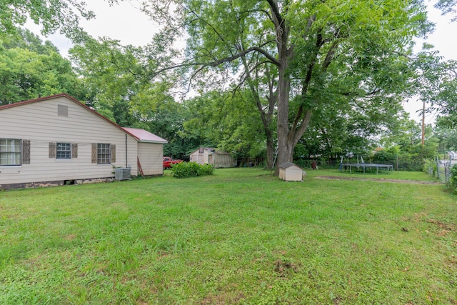 1502 E 49th St, Chattanooga, TN 37407 - view of yard with a trampoline, a shed, and view of scattered trees