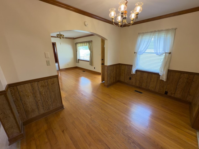 4630 Happy Valley Rd, Flintstone, GA 30725 - empty room with a wainscoted wall, ornamental molding, wood finished floors, arched walkways, and a chandelier