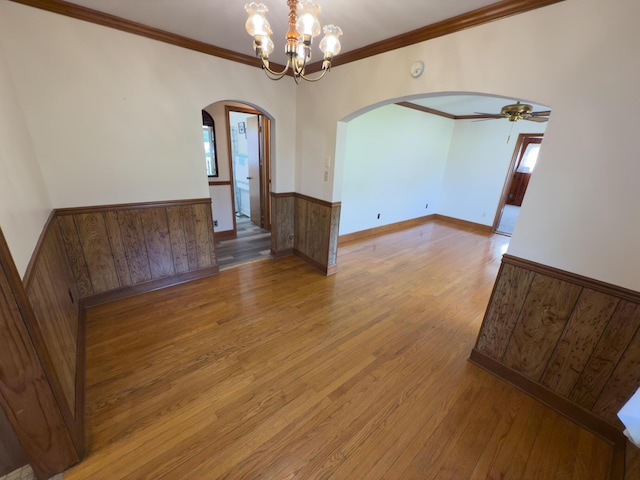 4630 Happy Valley Rd, Flintstone, GA 30725 - spare room featuring arched walkways, a wainscoted wall, light wood-type flooring, ceiling fan, and ornamental molding