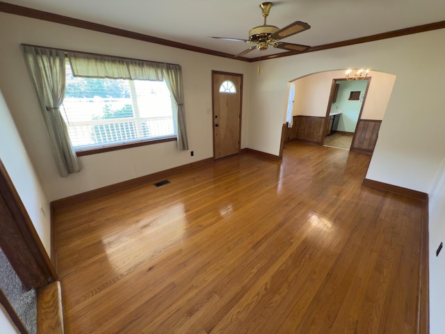 4630 Happy Valley Rd, Flintstone, GA 30725 - unfurnished living room featuring wood finished floors, arched walkways, ceiling fan, and ornamental molding