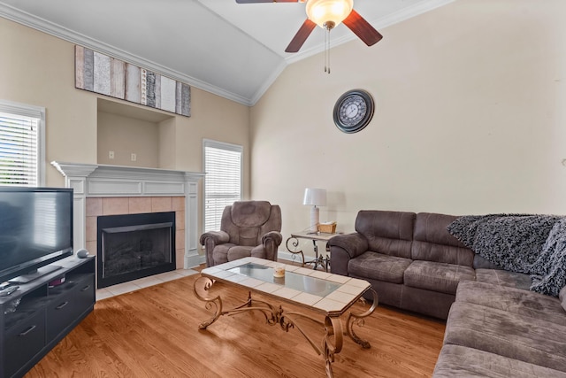 8189 Kaitlin Ln, Ooltewah, TN 37363 - living room with crown molding, lofted ceiling, ceiling fan, light wood finished floors, and a fireplace