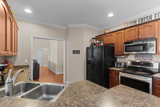 8189 Kaitlin Ln, Ooltewah, TN 37363 - kitchen with stainless steel appliances, crown molding, wood finished floors, brown cabinetry, and recessed lighting