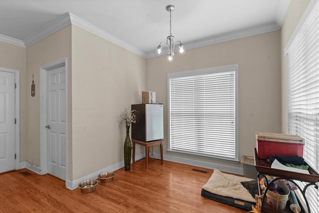8189 Kaitlin Ln, Ooltewah, TN 37363 - living area with wood finished floors, a chandelier, and ornamental molding
