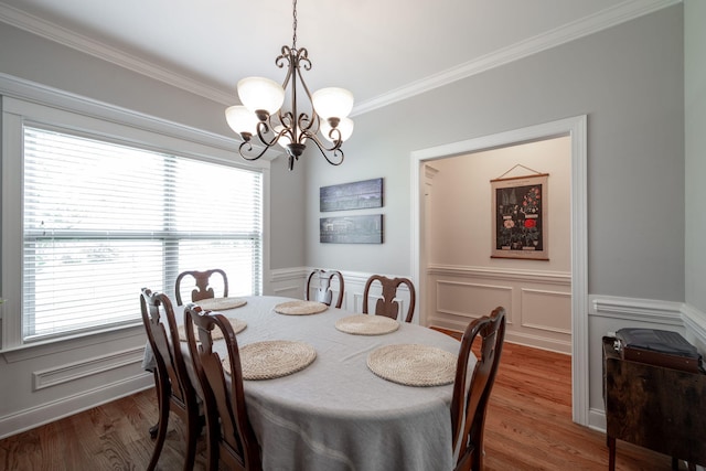 8502 Kennerly Ct, Ooltewah, TN 37363 - dining room with a chandelier, ornamental molding, wainscoting, wood finished floors, and a decorative wall