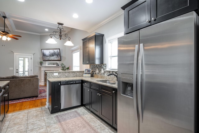 8502 Kennerly Ct, Ooltewah, TN 37363 - kitchen with appliances with stainless steel finishes, crown molding, open floor plan, light stone countertops, and a peninsula