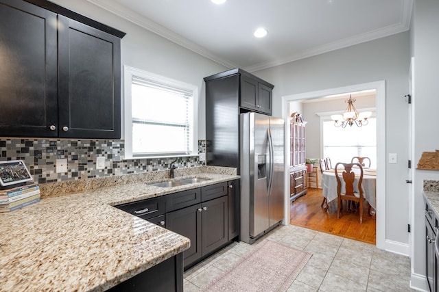 8502 Kennerly Ct, Ooltewah, TN 37363 - kitchen with stainless steel fridge with ice dispenser, a chandelier, crown molding, tasteful backsplash, and healthy amount of natural light