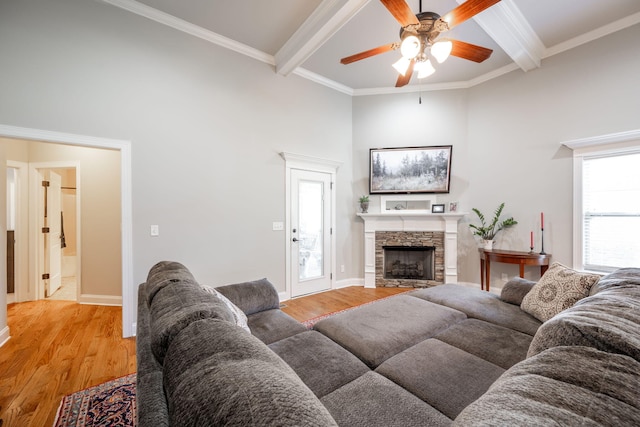 8502 Kennerly Ct, Ooltewah, TN 37363 - living area with a ceiling fan, light wood-style flooring, a high ceiling, beamed ceiling, and a stone fireplace