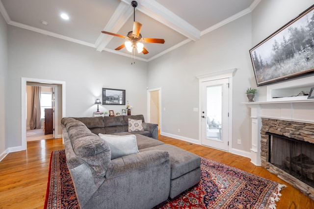 8502 Kennerly Ct, Ooltewah, TN 37363 - living area with a ceiling fan, a fireplace, light wood-type flooring, beamed ceiling, and a towering ceiling