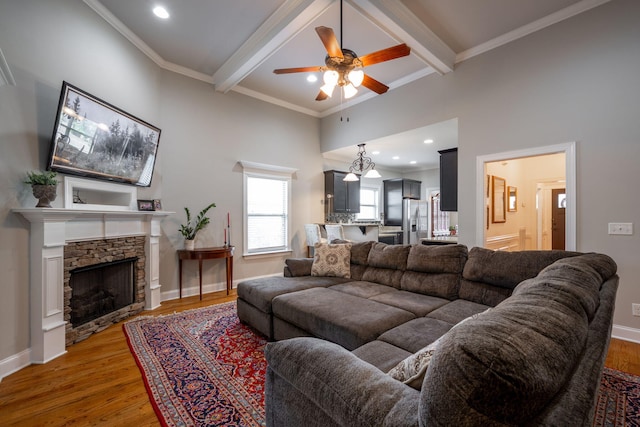 8502 Kennerly Ct, Ooltewah, TN 37363 - living area with a ceiling fan, light wood-type flooring, beam ceiling, crown molding, and a fireplace