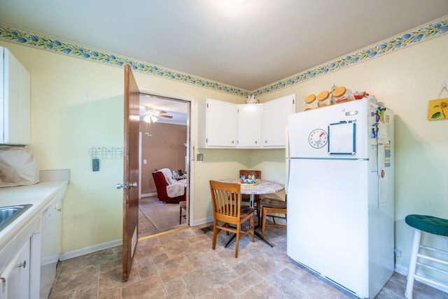 4312 Kemp Dr, Chattanooga, TN 37411 - kitchen featuring freestanding refrigerator, white cabinetry, stone finish floors, light countertops, and a ceiling fan