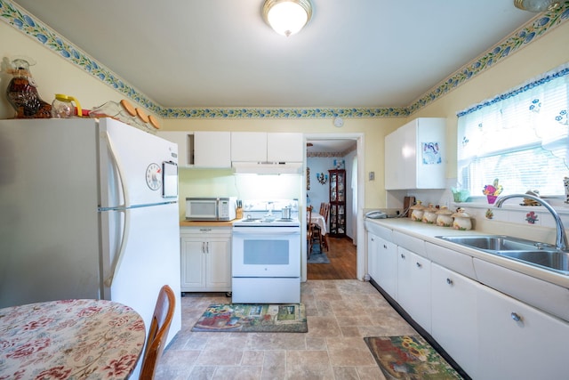 4312 Kemp Dr, Chattanooga, TN 37411 - kitchen featuring white appliances, under cabinet range hood, white cabinetry, and stone finish flooring