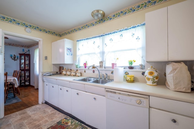 4312 Kemp Dr, Chattanooga, TN 37411 - kitchen with white dishwasher, light countertops, white cabinetry, light stone finish flooring, and backsplash
