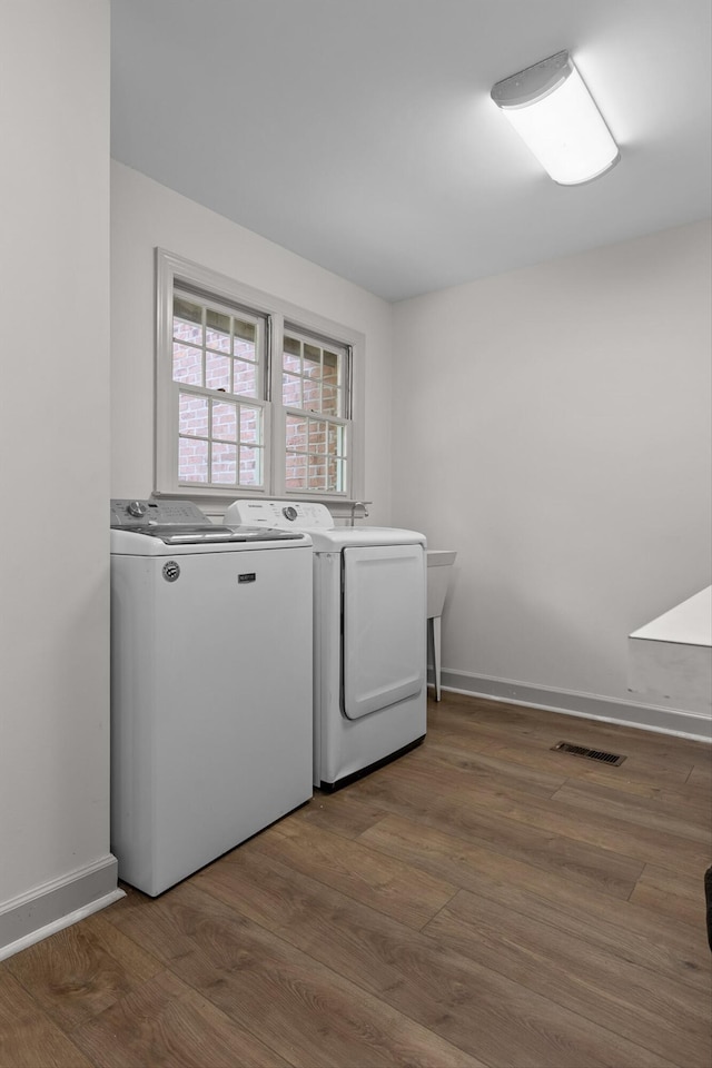 522 Rainsong Rd, Dalton, GA 30720 - laundry room with washing machine and clothes dryer and wood finished floors