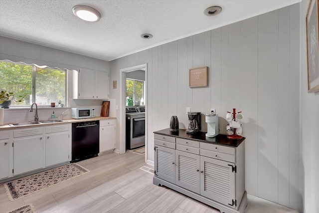 824 Graysville Rd, Chattanooga, TN 37421 - kitchen featuring dishwasher, white microwave, plenty of natural light, washing machine and clothes dryer, and a textured ceiling