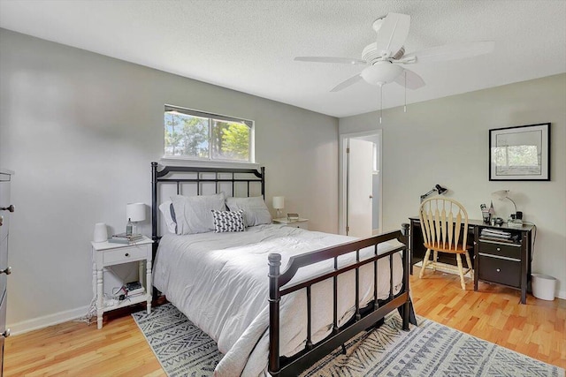 824 Graysville Rd, Chattanooga, TN 37421 - bedroom with light wood-style floors, a textured ceiling, and a ceiling fan