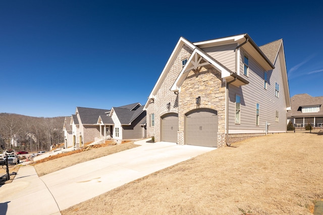 10619 Kavya Ln, Apison, TN 37302 - view of side of home featuring a garage, concrete driveway, and stone siding