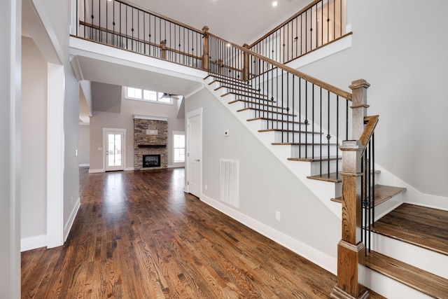 10619 Kavya Ln, Apison, TN 37302 - stairs featuring a high ceiling, wood finished floors, and a fireplace