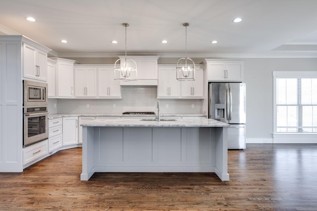 10619 Kavya Ln, Apison, TN 37302 - kitchen featuring appliances with stainless steel finishes, crown molding, a chandelier, a center island with sink, and white cabinetry