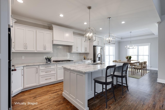 10619 Kavya Ln, Apison, TN 37302 - kitchen with a chandelier, stainless steel appliances, tasteful backsplash, custom range hood, and white cabinetry