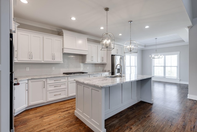 10619 Kavya Ln, Apison, TN 37302 - kitchen with a chandelier, stainless steel appliances, custom range hood, decorative backsplash, and white cabinetry