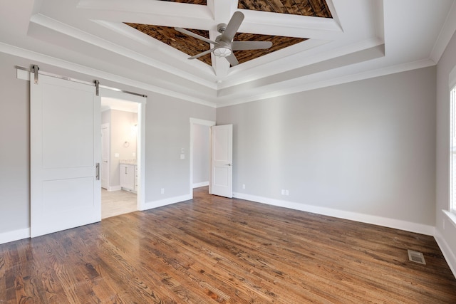 10619 Kavya Ln, Apison, TN 37302 - unfurnished bedroom with a raised ceiling, crown molding, a barn door, wood finished floors, and connected bathroom