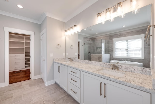 10619 Kavya Ln, Apison, TN 37302 - bathroom featuring ornamental molding, a stall shower, double vanity, a freestanding tub, and a walk in closet