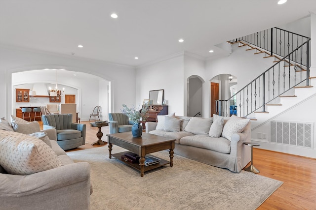 2109 E Brow Rd, Walden, TN 37377 - living area with arched walkways, ornamental molding, stairs, light wood-style floors, and recessed lighting