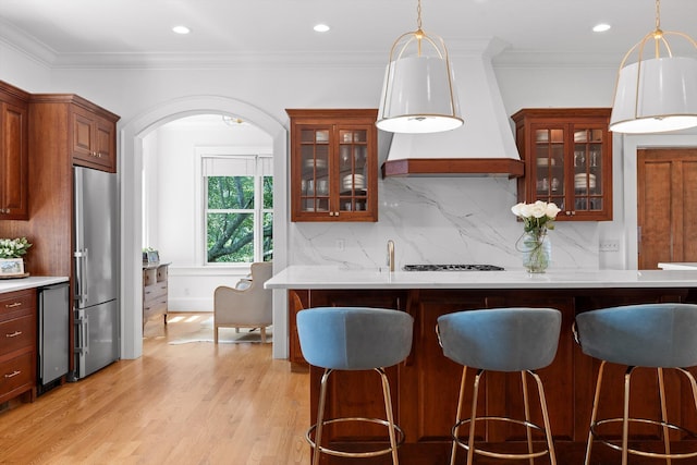 2109 E Brow Rd, Walden, TN 37377 - kitchen with high end refrigerator, a breakfast bar area, light countertops, custom range hood, and recessed lighting