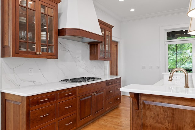 2109 E Brow Rd, Walden, TN 37377 - kitchen with custom exhaust hood, stainless steel gas stovetop, light countertops, glass insert cabinets, and crown molding