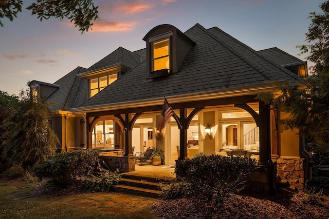2109 E Brow Rd, Walden, TN 37377 - back of property at dusk with a shingled roof and stucco siding