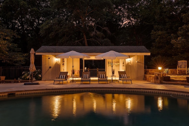 2109 E Brow Rd, Walden, TN 37377 - pool at night featuring an exterior structure, an outbuilding, a patio area, and an outdoor pool