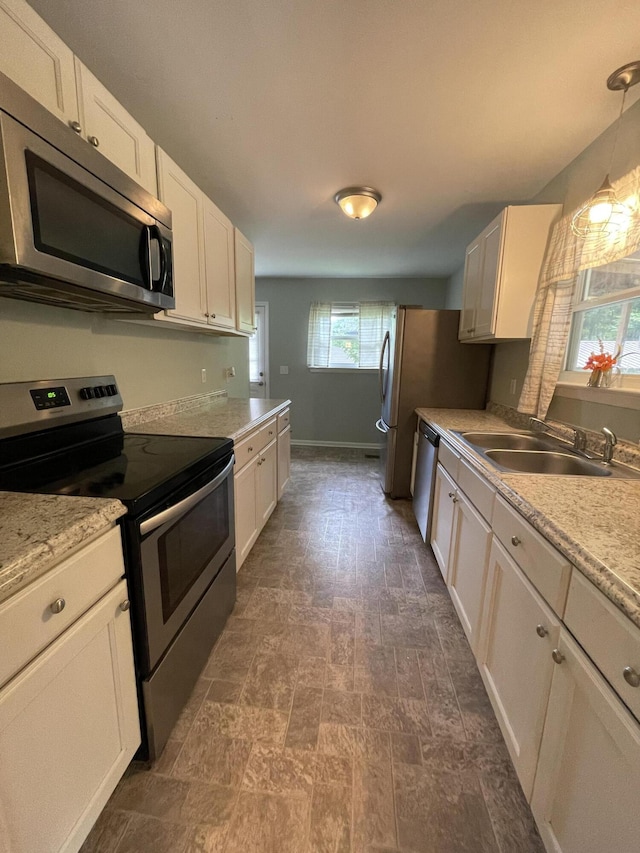 4702 Eldridge Rd, Hixson, TN 37343 - kitchen with stainless steel appliances, white cabinetry, and pendant lighting